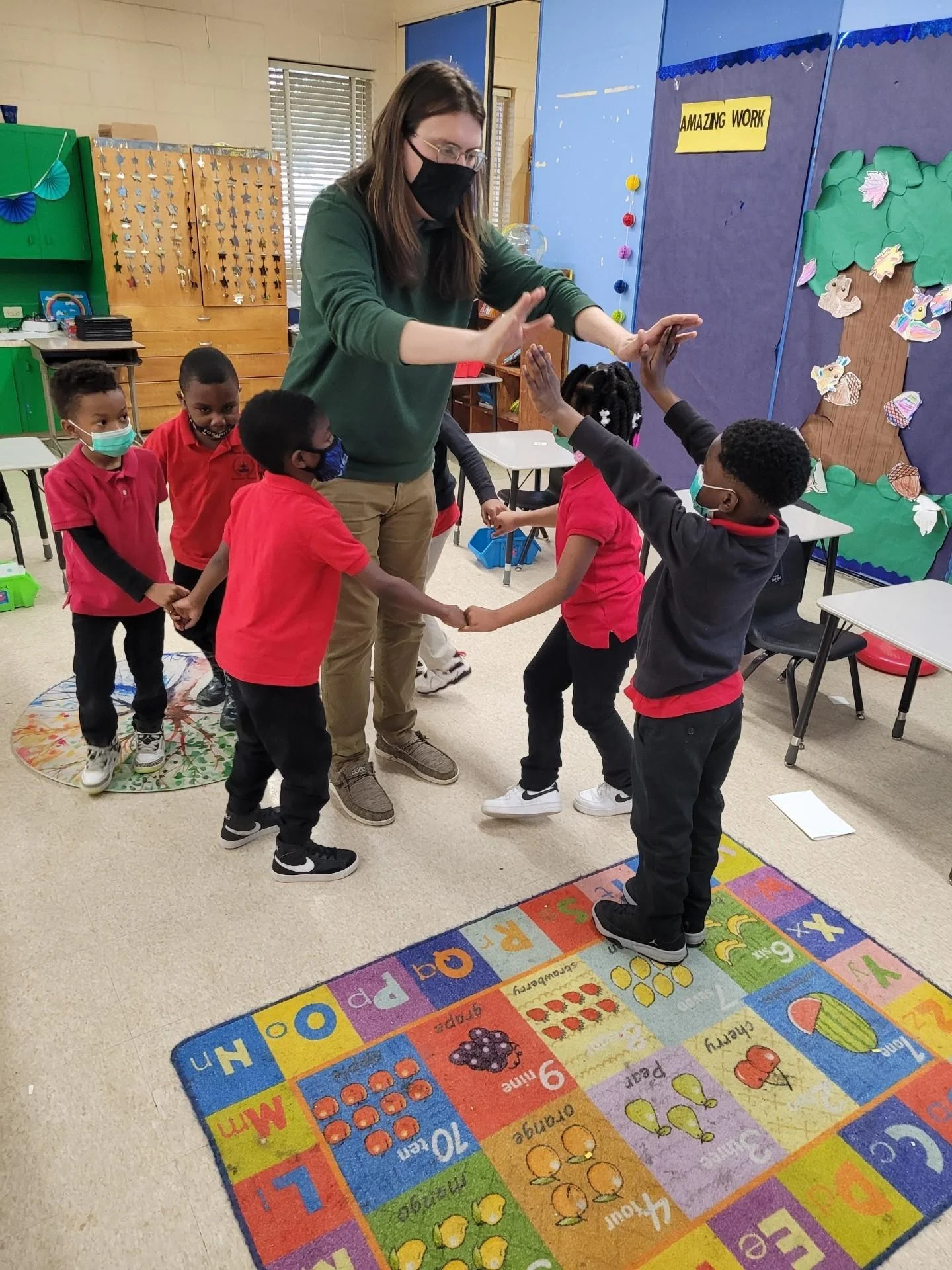 PRAMS students high-fiving teacher