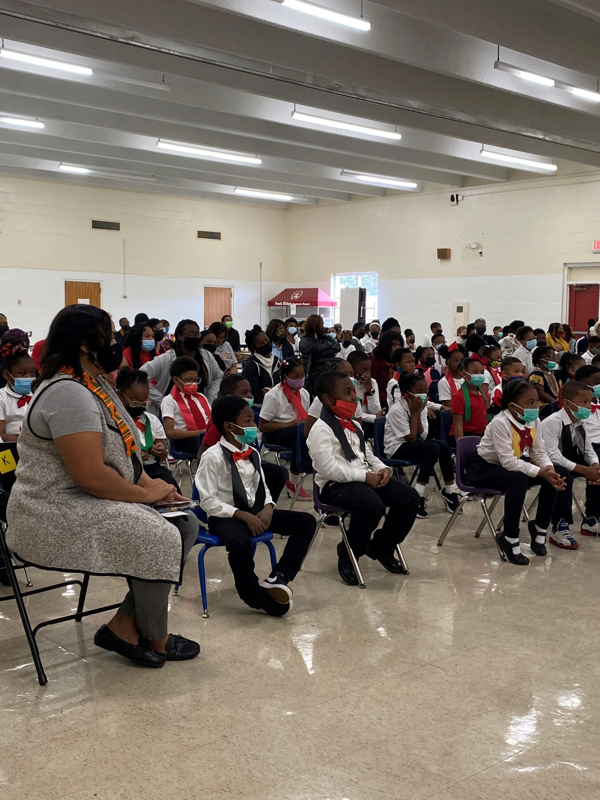 students sitting at assembly