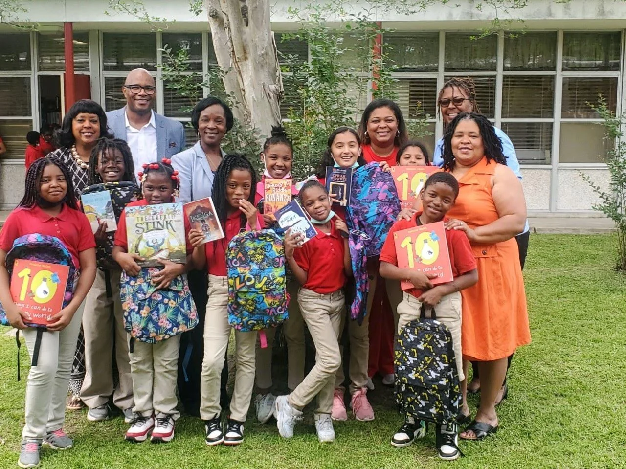 students and teachers holding books