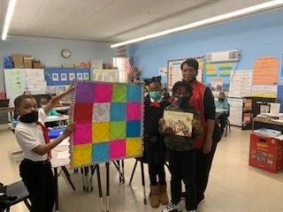 Mrs. Odell's class with handmade quilt